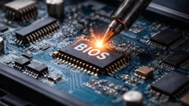 Close-up of a circuit board with a BIOS chip being soldered, showcasing intricate electronic components and connections.