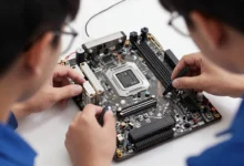 Two individuals examining a computer motherboard with tools, focusing on the central processing unit and circuit components.